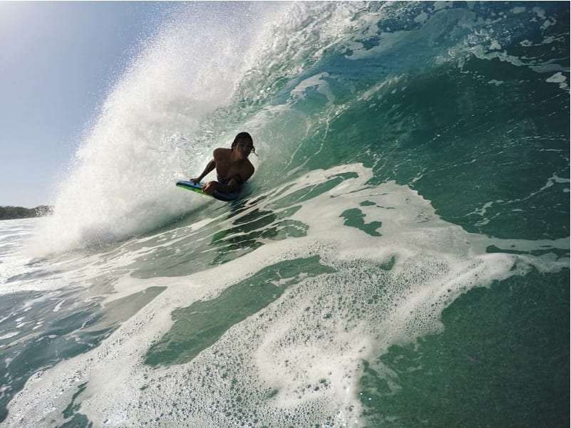 Bodyboarder riding inside a curling wave