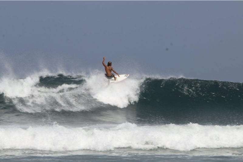 Surfer in the air above a breaking wave
