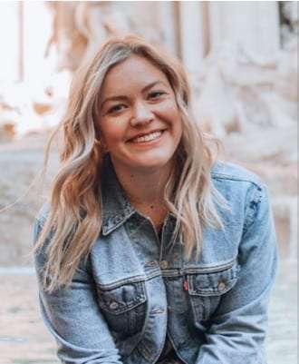 Portrait of Gina Roscoe, a smiling woman with long blonde hair in a denim jacket